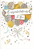 In this image, a refined congratulations card stands like a small celebration in itself, the front completely adorned with a cascade of balloons and sparkling detail. The design centres on a bouquet of rounded balloons, gathered together as if rising above the busy streets near Ealing Road and into a quieter, brighter sky. Soft metallic golds, silvers, champagne tones, sky blues, blush pinks, and gentle greys melt into one another, with each balloon decorated in its own style: fine star motifs, slender stripes, or textured glitter accents that catch the eye. Thin, shimmering balloon strings fall in sweeping arcs, crossing and looping at the bottom like the graceful stems of a florist's creation, lending the scene a sense of unity and flow. Around them, scattered stars, tiny dots of confetti, and playful ribbon curls drift across a light, creamy background, suggesting that the air itself is full of happiness. Cutting horizontally through the central cluster, a soft banner unfurls, neatly framing the words Congratulations To You in an elegant, flowing script that feels heartfelt yet timeless. The mood of the card is open and inclusive, suited to many kinds of achievement-a student in Alperton celebrating exam success, a neighbour marking a promotion, or a family member moving into a new flat nearby. The composition balances glamour and warmth, making it a natural companion to a fresh bouquet delivered locally, ready to be placed on a windowsill where the metallic details can glimmer softly in the afternoon light.