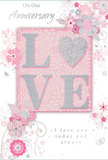 A soft, romantic anniversary card rendered in a pearlescent palette of blush pinks, warm mauves and silvery greys, designed to read like a miniature floral tableau. At its centre the word 'LOVE' sits in raised, frosted glitter-each letter catching the light with a gentle sparkle, the 'O' suggested as a shimmering heart textured in silver. Surrounding that focal sentiment, delicate stylised blooms and wispy sprays unfurl in fine, almost watercolor washes: blush roses, pale mauve buds and tiny ivory petals sketched with thin, confident lines. Subtle silver foil highlights trace the veins of leaves and the edges of tiny butterflies that seem to float across the soft pink background, their presence as light and fleeting as a spring breeze. The surface invites touch-the glitter-kissed typography slightly tactile against the smooth card stock-while the composition suggests a scent memory, the faint sweetness of cut flowers left in a sunlit kitchen. Printed messages, 'On Our Anniversary' and 'I love you today and always,' sit in an understated, elegant script, the typeface breathing sincerity and quiet celebration into the design. As a florist I picture this card tucked into a hand-tied posy from an Ealing Road market bunch or slipped into a bouquet for delivery around Alperton and nearby Wembley, an intimate keepsake that mirrors the care of a locally gathered arrangement. Gentle light seems to wash the scene from the left, softening edges and lending the whole image a nostalgic, tender glow-perfect for marking a shared milestone with warmth, memory and the promise of many more springs together.